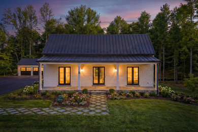 Example of a large transitional white two-story wood and shingle house exterior design in DC Metro with a shed roof and a metal roof