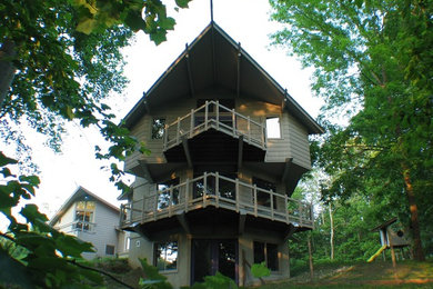 Example of a minimalist gray three-story wood exterior home design in Baltimore with a shingle roof
