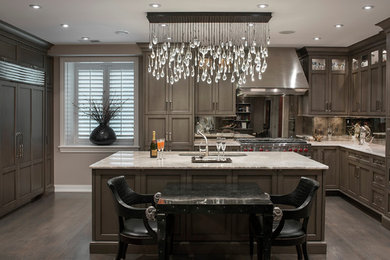 Eat-in kitchen - u-shaped eat-in kitchen idea in Chicago with recessed-panel cabinets, stainless steel appliances and an island