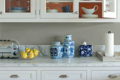 Inspiration for a mid-sized transitional single-wall enclosed kitchen remodel in San Francisco with beaded inset cabinets, white cabinets, marble countertops, beige backsplash and no island