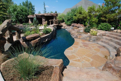 Pool - huge traditional backyard concrete paver and custom-shaped pool idea in Oklahoma City