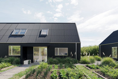 Modelo de fachada de casa negra y negra costera de tamaño medio de una planta con revestimiento de aglomerado de cemento y tejado a dos aguas