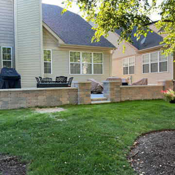 A Raised Paver Patio with Seating Walls & Stone Pillars — Aurora