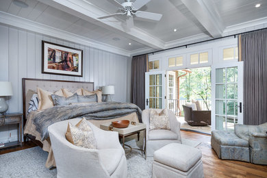 Bedroom - rustic master medium tone wood floor bedroom idea in Other with gray walls