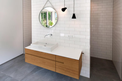 Inspiration for a medium sized shower room bathroom in Other with flat-panel cabinets, light wood cabinets, white tiles, solid surface worktops, white worktops, a single sink and a freestanding vanity unit.