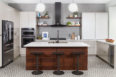 Example of a trendy kitchen design in Austin with flat-panel cabinets, white cabinets, gray backsplash, stainless steel appliances and an island
