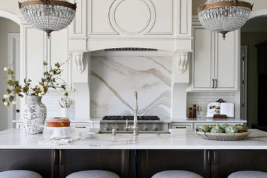 Large transitional l-shaped dark wood floor and brown floor open concept kitchen photo in Nashville with a single-bowl sink, raised-panel cabinets, white cabinets, quartz countertops, white backsplash, subway tile backsplash, stainless steel appliances, an island and white countertops