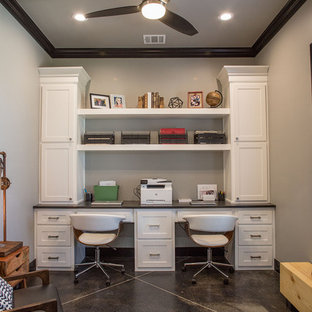 Medium sized modern study in Other with grey walls, concrete flooring, a built-in desk, black floors and no fireplace.