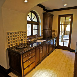 Large mediterranean kitchen pantry ideas - Example of a large tuscan l-shaped dark wood floor kitchen pantry design in Santa Barbara with an undermount sink, recessed-panel cabinets, light wood cabinets, granite countertops, multicolored backsplash, porcelain backsplash, stainless steel appliances and an island