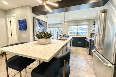 Kitchen - transitional kitchen idea in Calgary with flat-panel cabinets, blue cabinets, solid surface countertops and an island