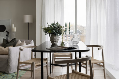 This is an example of a small modern open plan dining room in London with beige walls.
