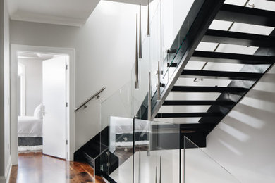 Staircase - modern wooden u-shaped open and glass railing staircase idea in Chicago