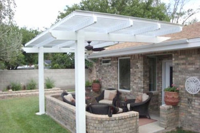Design ideas for a backyard patio in Salt Lake City with brick pavers and an awning.