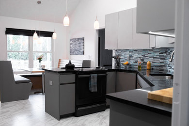 Eat-in kitchen - mid-sized modern ceramic tile eat-in kitchen idea in Other with a single-bowl sink, flat-panel cabinets, blue backsplash, glass tile backsplash and black appliances