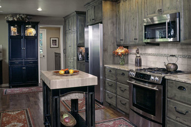 Eat-in kitchen - large eclectic galley medium tone wood floor eat-in kitchen idea in Other with medium tone wood cabinets, granite countertops, stone tile backsplash, stainless steel appliances and an island