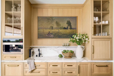 Example of a transitional home bar design in Orange County