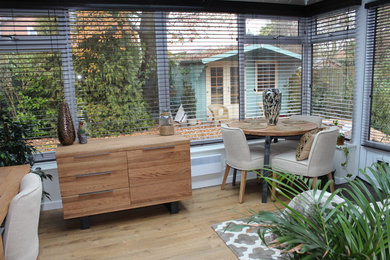 Inspiration for a medium sized world-inspired conservatory in West Midlands with medium hardwood flooring.