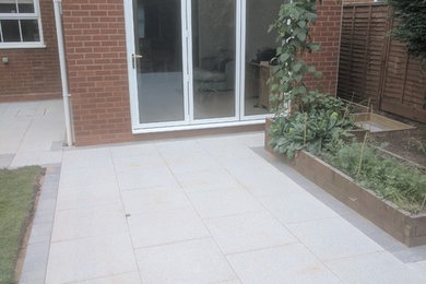Inspiration for a medium sized modern back formal partial sun garden for summer in West Midlands with a vegetable patch and concrete paving.