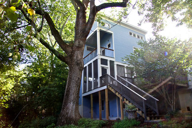 Mid-sized elegant blue three-story wood house exterior photo in Atlanta with a shed roof