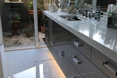 Contemporary bathroom in Tampa with flat-panel cabinets, grey cabinets, white tile, marble, marble floors, an undermount sink, marble benchtops, white floor and a sliding shower screen.