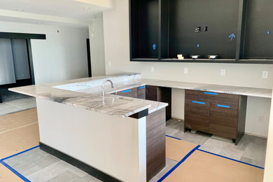 Example of a mid-sized trendy l-shaped ceramic tile and gray floor wet bar design in Indianapolis with an undermount sink, flat-panel cabinets, brown cabinets, quartzite countertops and white countertops