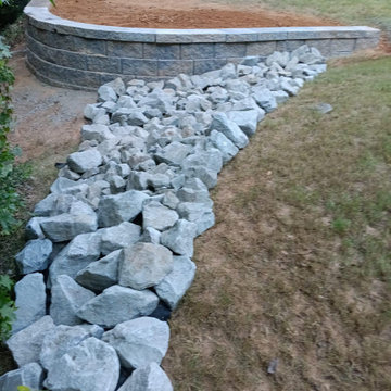 Retaining wall extension with rip rap rock