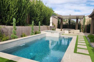 Pool - mid-sized modern backyard stone and rectangular pool idea in Las Vegas