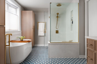 Bathroom - large transitional master white tile and porcelain tile porcelain tile, multicolored floor and double-sink bathroom idea in Chicago with recessed-panel cabinets, light wood cabinets, a two-piece toilet, gray walls, a drop-in sink, quartz countertops, a hinged shower door, white countertops, a niche and a built-in vanity