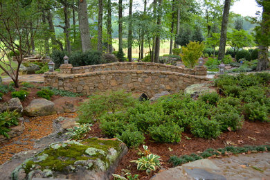This is an example of a huge traditional shade backyard stone garden path in Other for summer.
