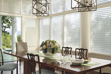 Mid-sized trendy dark wood floor and brown floor enclosed dining room photo in Phoenix with white walls and no fireplace