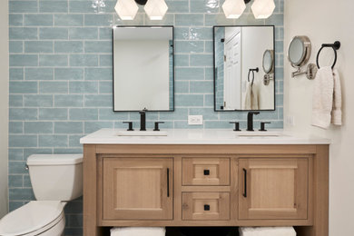 Mid-sized transitional master blue tile and porcelain tile porcelain tile, gray floor and double-sink bathroom photo in Chicago with recessed-panel cabinets, brown cabinets, quartzite countertops, a hinged shower door, white countertops and a freestanding vanity