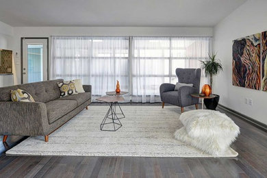 Inspiration for a large scandinavian formal and open concept dark wood floor living room remodel in San Diego with white walls, no fireplace and no tv