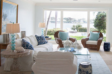 Living room - large coastal formal and open concept travertine floor and brown floor living room idea in Miami with blue walls, no fireplace and no tv