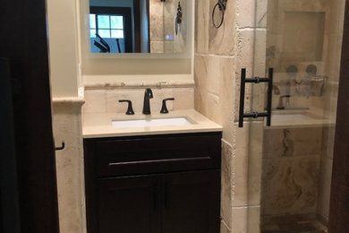 Inspiration for a mid-sized mediterranean master beige tile and travertine tile double shower remodel in Other with shaker cabinets, beige cabinets, a two-piece toilet, an undermount sink and a hinged shower door