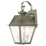 Livex Lighting Lights - Mansfield Outdoor Wall Lantern, Vintage Pewter - Illuminate a driveway or terrace area with the Mansfield Wall Lantern. Modeled on traditional, Victorian-style lamps, it features a bronze shade with seeded glass panels suspended from a curved mount. The lantern is weatherproof and makes an elegant addition to an exterior wall or porch.