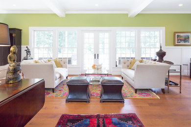 Large eclectic formal and enclosed medium tone wood floor living room photo in Seattle with green walls and a wall-mounted tv