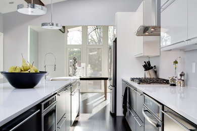 Design ideas for a mid-sized contemporary galley kitchen in Louisville with an undermount sink, flat-panel cabinets, black cabinets, white splashback and with island.