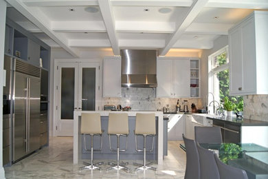 Large transitional l-shaped marble floor, white floor and coffered ceiling enclosed kitchen photo in Toronto with a farmhouse sink, shaker cabinets, gray cabinets, quartz countertops, white backsplash, marble backsplash, stainless steel appliances, an island and beige countertops