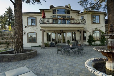 Inspiration for a mid-sized timeless beige one-story stucco exterior home remodel in Other with a shingle roof