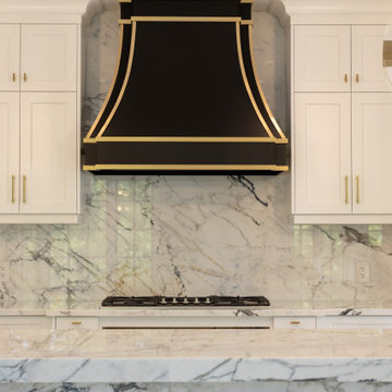 Full-Height Book-Matched Marble Backsplash Behind Range
