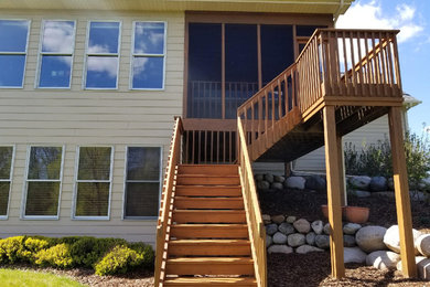 Mid-sized elegant side yard deck photo in Minneapolis with no cover