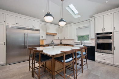 Eat-in kitchen - traditional eat-in kitchen idea in Toronto with shaker cabinets, white cabinets, gray backsplash, marble backsplash, stainless steel appliances and an island