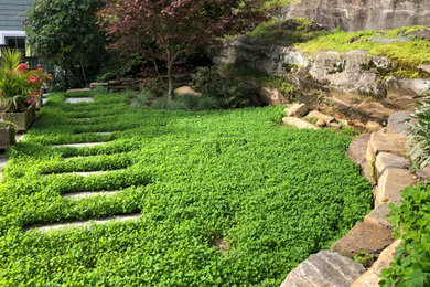 Design ideas for a small transitional drought-tolerant and full sun backyard river rock retaining wall landscape in New York for summer.