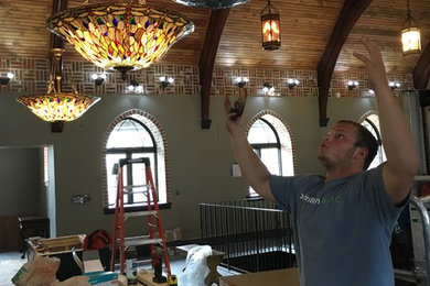 Nick is putting these light fixtures over the kitchen island.