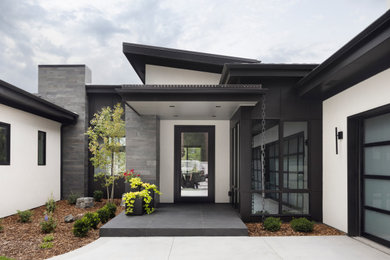 Example of a large trendy beige two-story metal exterior home design in Denver