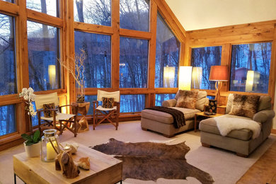 Sunroom - mid-sized rustic carpeted sunroom idea in Other with a standard fireplace and a stone fireplace