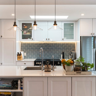 Mid-sized traditional kitchen pantry appliance - Kitchen pantry - mid-sized traditional galley gray floor kitchen pantry idea in Christchurch with an undermount sink, shaker cabinets, white cabinets, quartz countertops, gray backsplash, subway tile backsplash, stainless steel appliances and an island