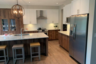 Inspiration for a large modern l-shaped medium tone wood floor and brown floor kitchen pantry remodel in Ottawa with an undermount sink, flat-panel cabinets, medium tone wood cabinets, quartz countertops, white backsplash, ceramic backsplash, stainless steel appliances, an island and gray countertops
