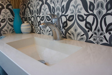 Inspiration for a mid-sized 3/4 bathroom remodel in Philadelphia with a two-piece toilet, white walls, an integrated sink and quartz countertops