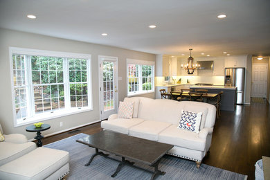 Family room - transitional open concept dark wood floor family room idea in Philadelphia with gray walls, a wall-mounted tv, a standard fireplace and a stone fireplace